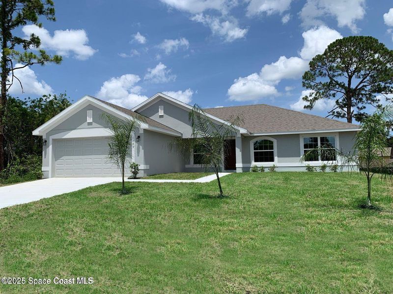 Front exterior of a new home in Palm Bay, Palm Bay, FL, highlighting curb appeal (Image 1).