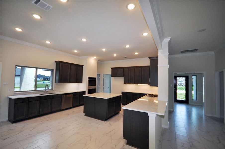 Large Island kitchen with an eat in breakfast area and flush bartop.