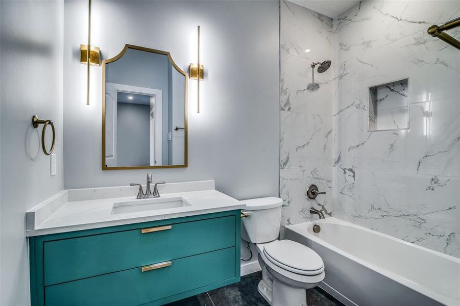 Full bathroom featuring vanity, toilet, and tiled shower / bath