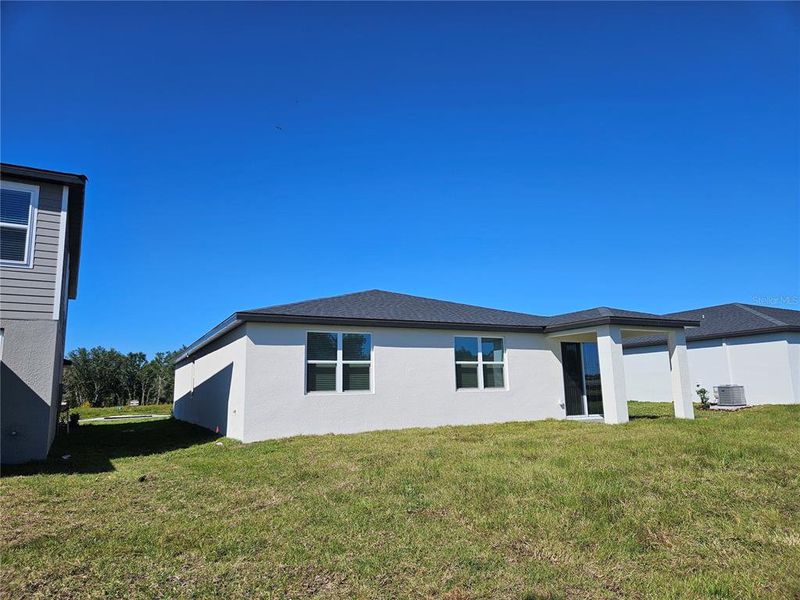 Exterior details and patio area of a home in The Reserve at Hammock Oaks - Signature Series, Lady Lake (Image 3).