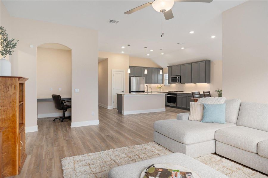 View from living room to office nook and kitchen.