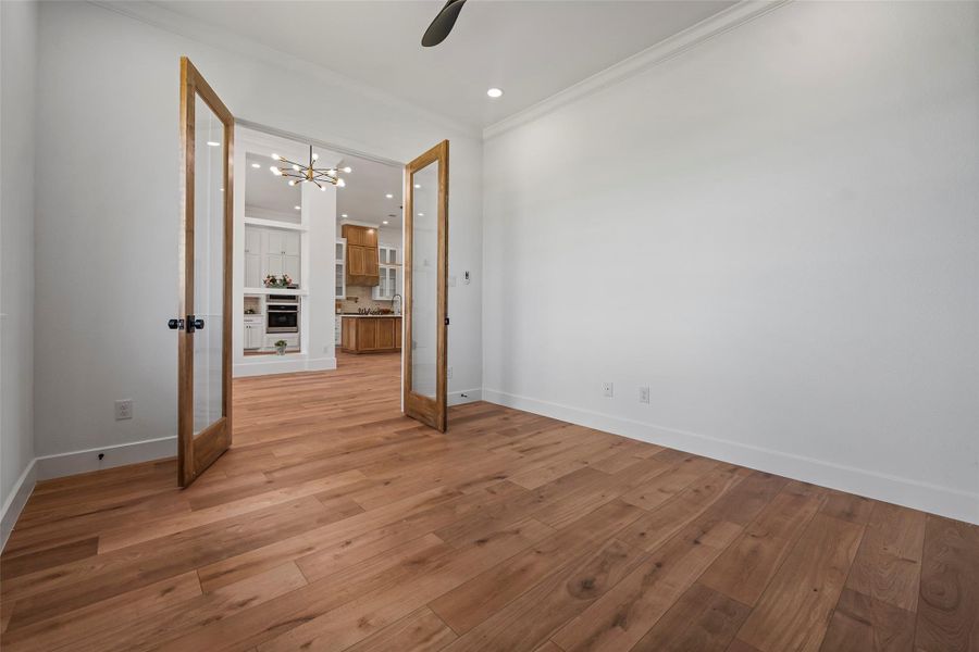 This bright and inviting office space features elegant French doors and beautiful hardwood floors, perfect for productivity and inspiration.