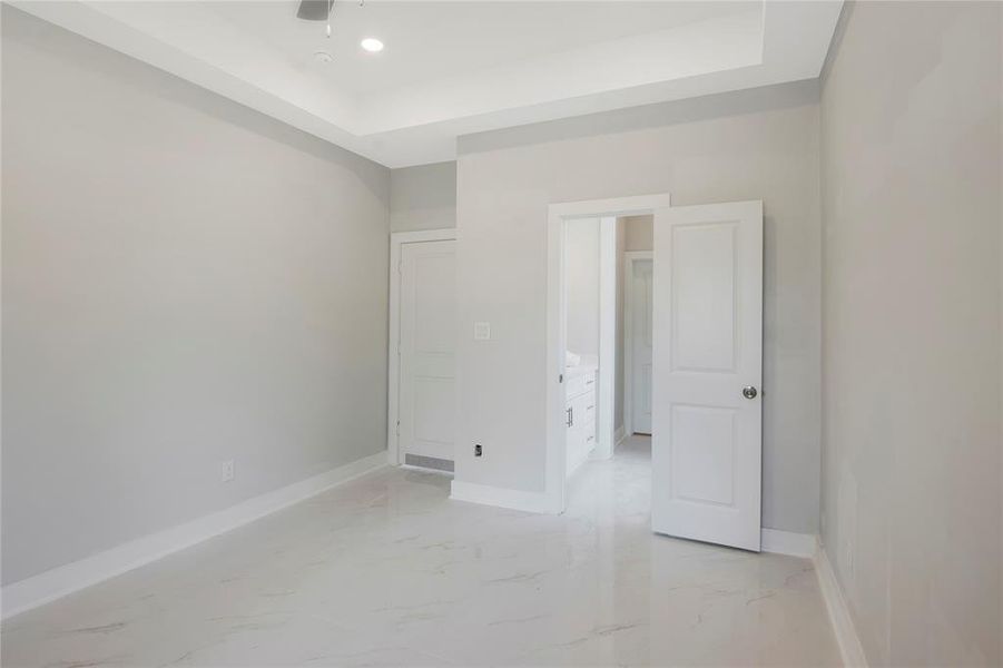 Primary bedroom with view into the bathroom.