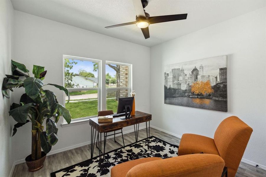 Living area featuring wood-type flooring and ceiling fan