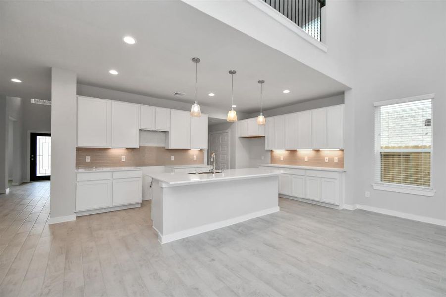 Beautiful bright kitchen space making meal prep enjoyable. Sample photo of completed home with similar plan. As built color and selections may vary.