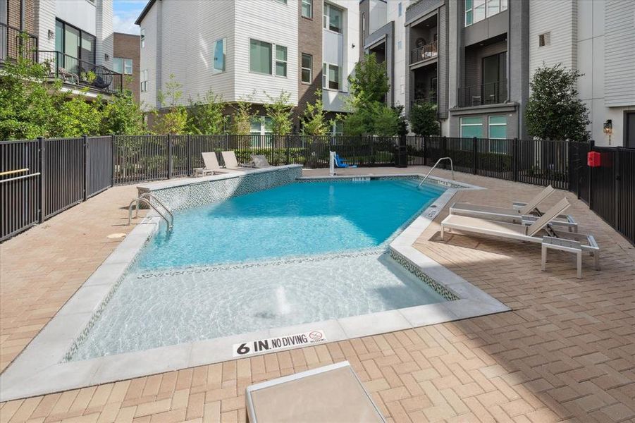 Community pool with a patio