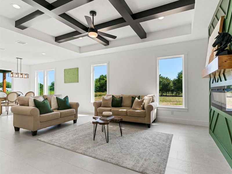 Living room featuring coffered ceiling, beam ceiling, recessed lighting, and a ceiling fan