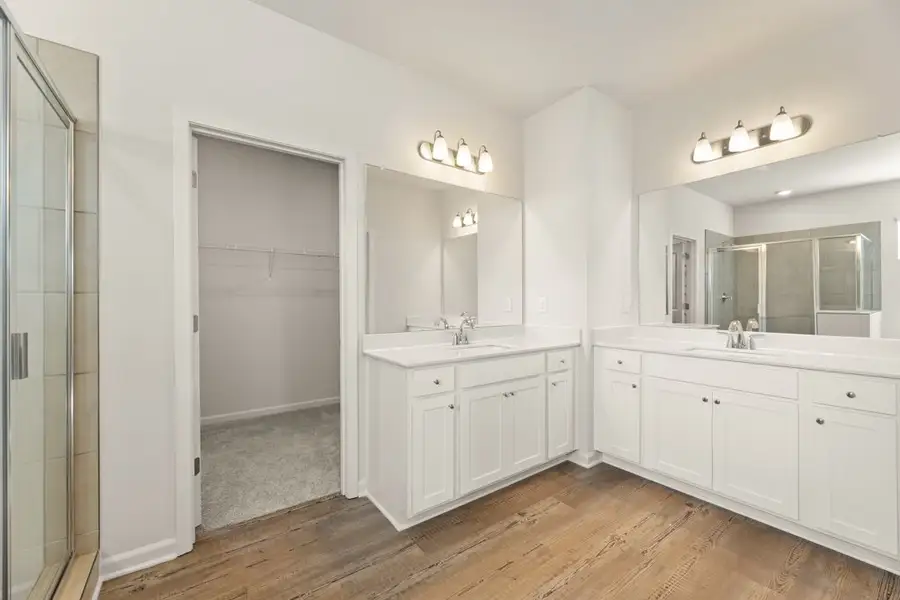 A bathroom with white cabinets. A bathroom with white cabinets.