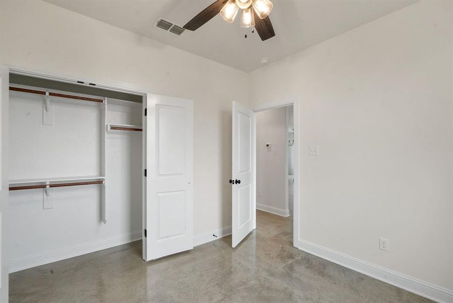 Unfurnished bedroom featuring ceiling fan and a closet