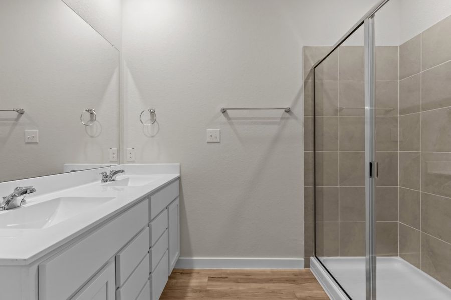 A bathroom with a glass shower. A bathroom with a glass shower.