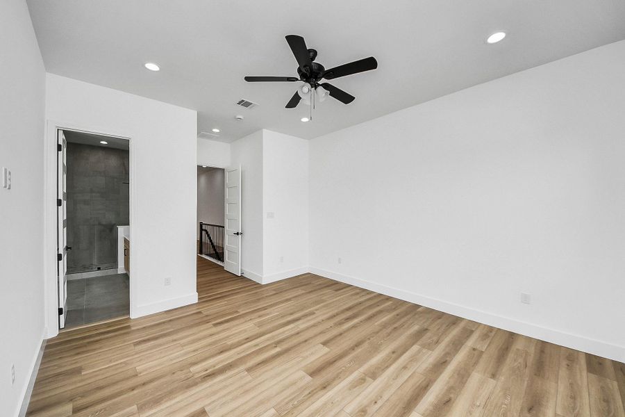 Spacious primary bedroom with great natural light and private balcony access—perfect for a quiet retreat.