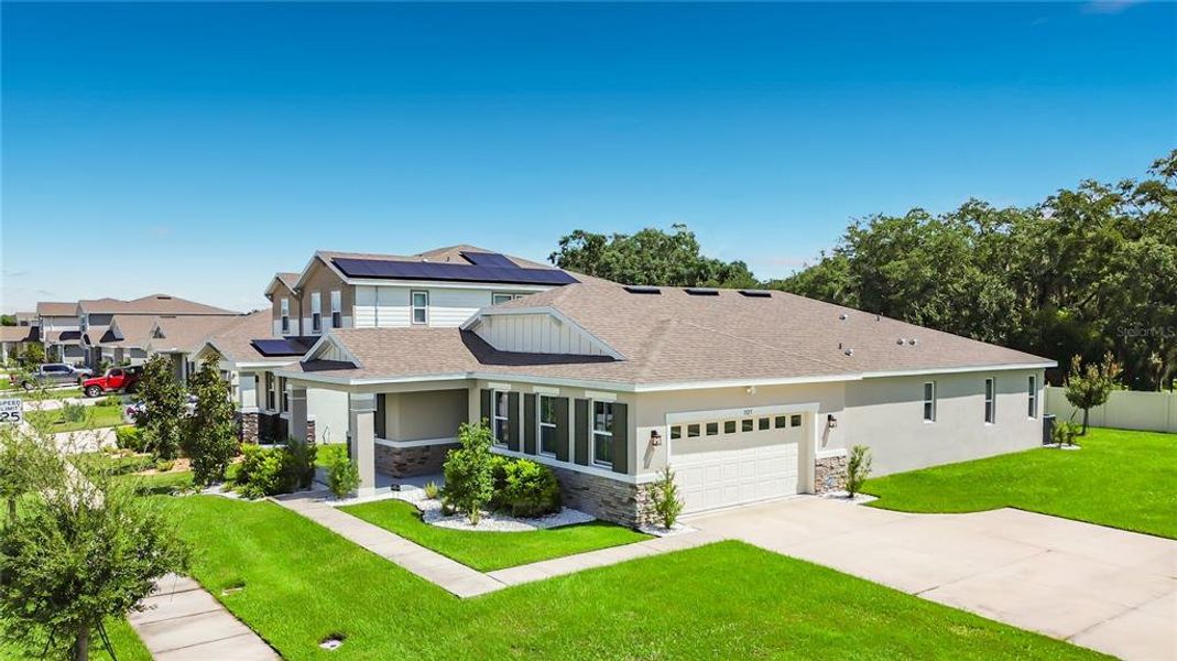 Front exterior of a new home in Seasons at Big Sky, Kissimmee, FL, highlighting curb appeal (Image 25).