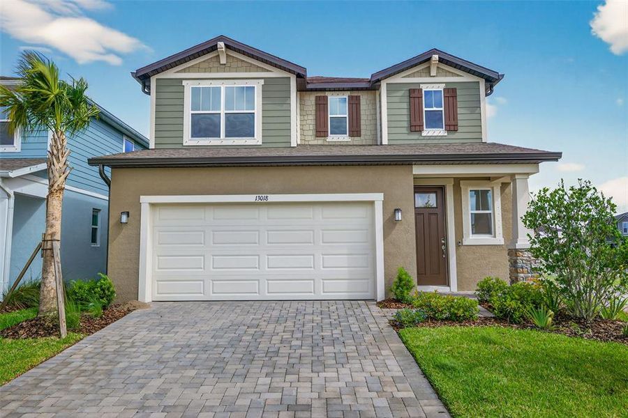 Front exterior of a new home in Crosswind Ranch, Parrish, FL, highlighting curb appeal (Image 1). Front exterior of a new home in Crosswind Ranch, Parrish, FL, highlighting curb appeal (Image 1).