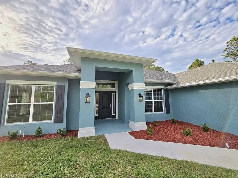 Front exterior of a new home in Lehigh Acres, Lehigh Acres, FL, highlighting curb appeal (Image 2).