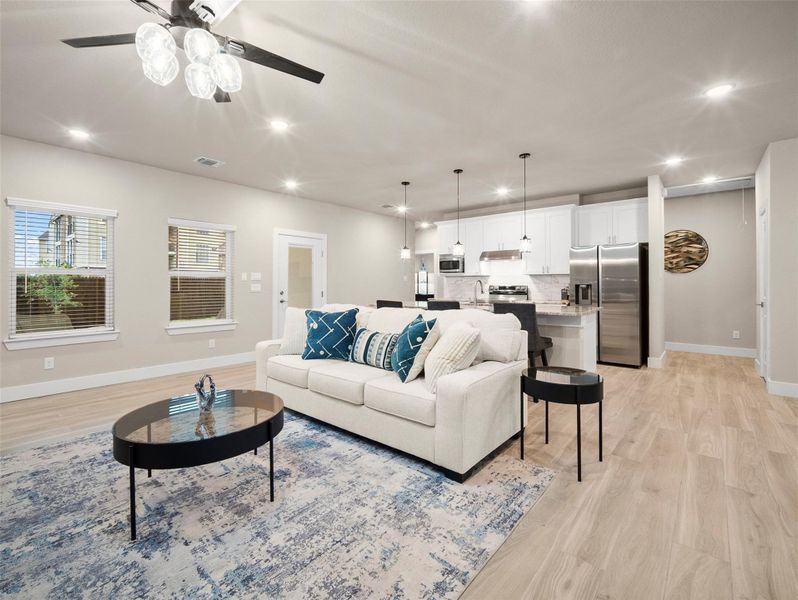 Living area with recessed lighting and light wood-type flooring Living area with recessed lighting and light wood-type flooring