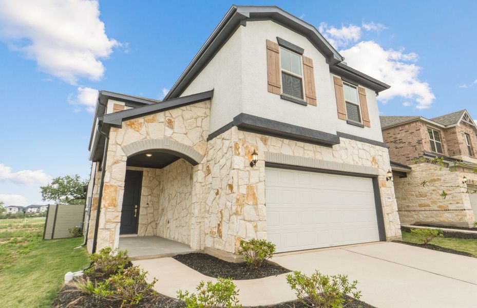 Front exterior of a new home in Wolf Ranch, Georgetown, TX, highlighting curb appeal (Image 1). Front exterior of a new home in Wolf Ranch, Georgetown, TX, highlighting curb appeal (Image 1).