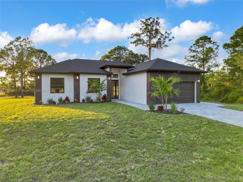Front exterior of a new home in , Lehigh Acres, FL, highlighting curb appeal (Image 17).