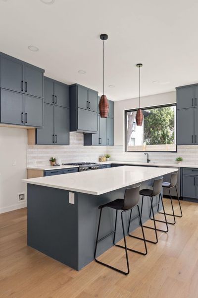 Culinary dreams come alive in this kitchen featuring abundant cabinetry and a large central island.