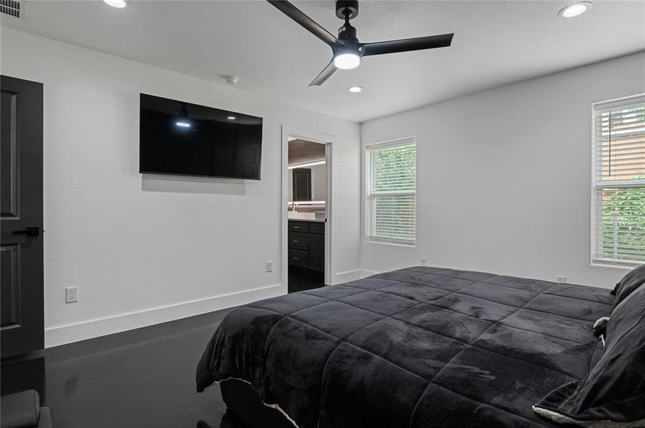 Bedroom featuring ensuite bathroom and ceiling fan