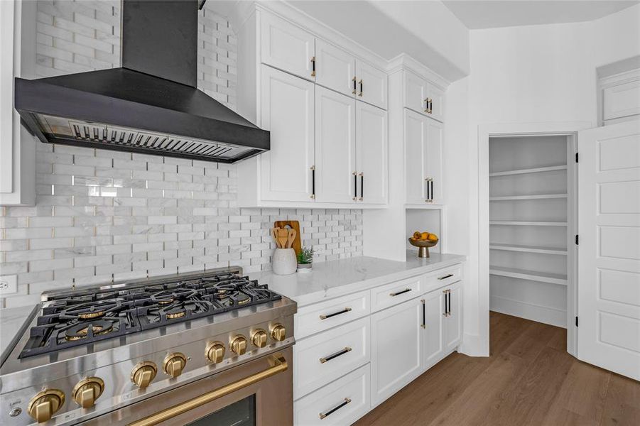 Marble subway backsplash with gold inlay, 2-toned knurled cabinet hardware, & walk-in pantry (only partially shown in this photo) Marble subway backsplash with gold inlay, 2-toned knurled cabinet hardware, & walk-in pantry (only partially shown in this photo)