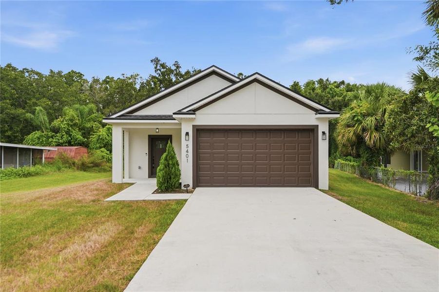 Front exterior of a new home in , Orlando, FL, highlighting curb appeal (Image 25).