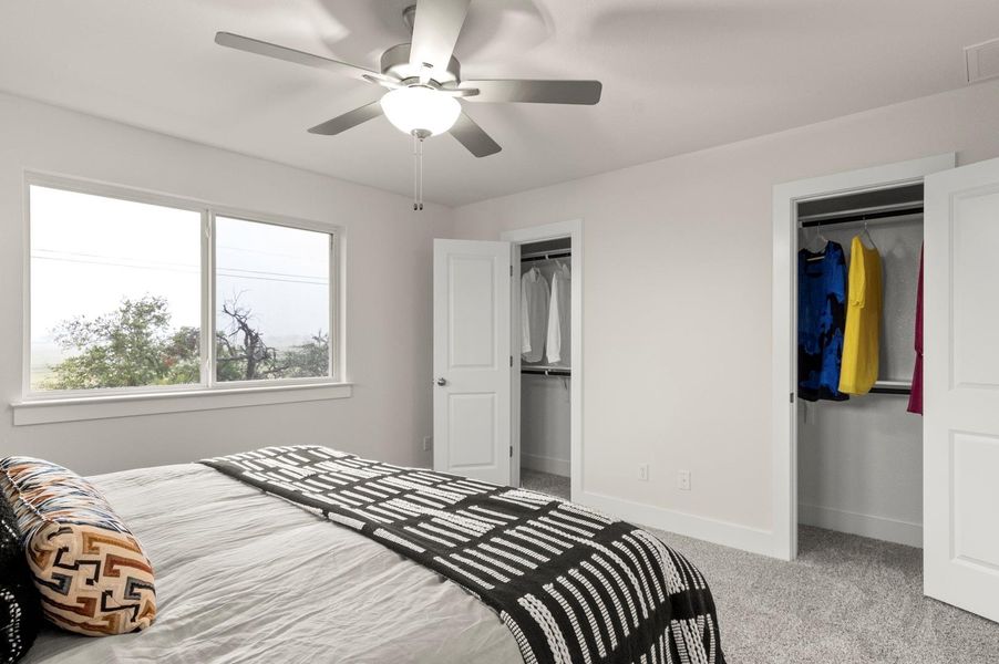 A well-lit sleeping sanctuary features a window offering views of the natural surroundings.