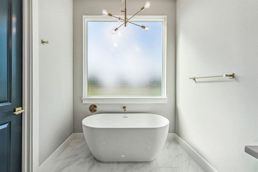 Bathroom with tile patterned floors and plenty of natural light