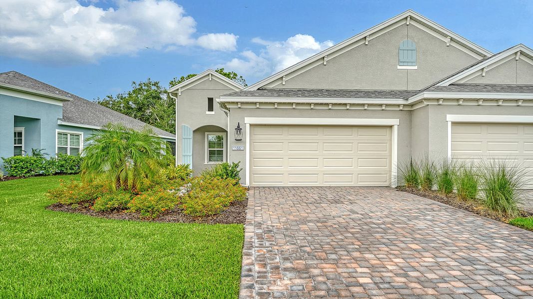 Front exterior of a new home in Wildleaf Real Estate and Homes for Sale in Parrish, FL - Neal Communities, Parrish, FL, highlighting curb appeal (Image 2). Front exterior of a new home in Wildleaf Real Estate and Homes for Sale in Parrish, FL - Neal Communities, Parrish, FL, highlighting curb appeal (Image 2).