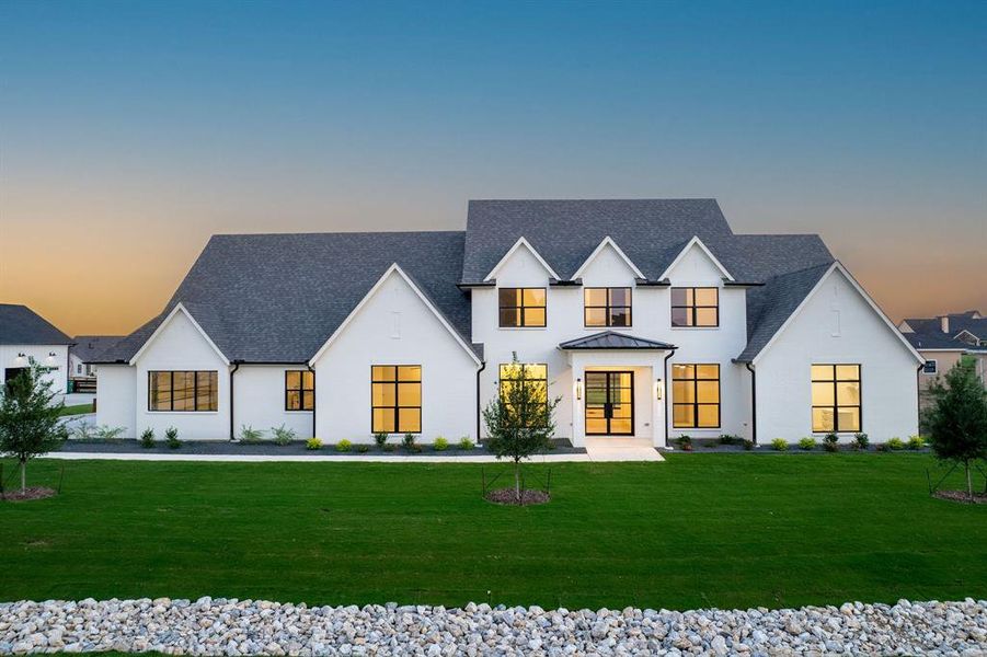 View of front of property with a yard and a shingled roof View of front of property with a yard and a shingled roof