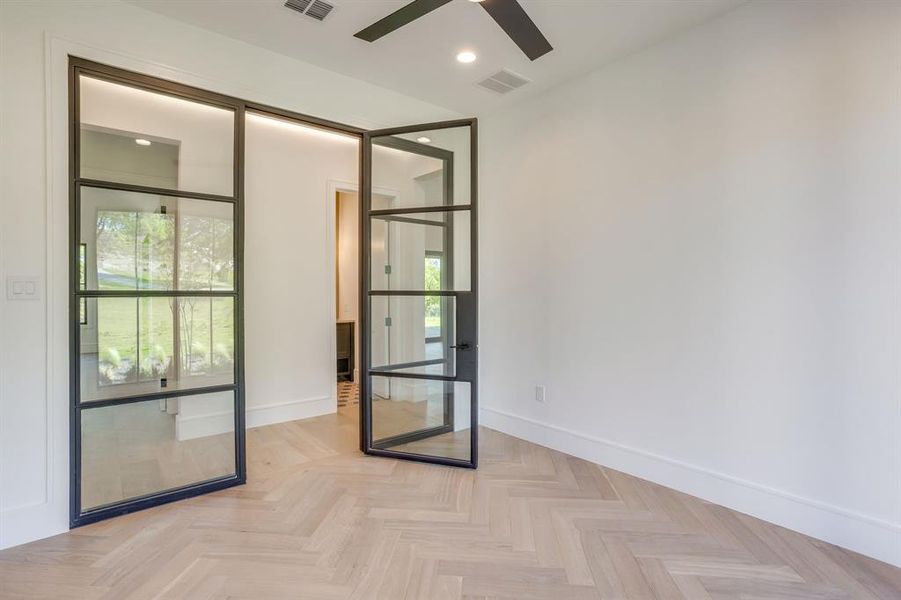 Empty room featuring parquet flooring, a ceiling fan, and recessed lighting