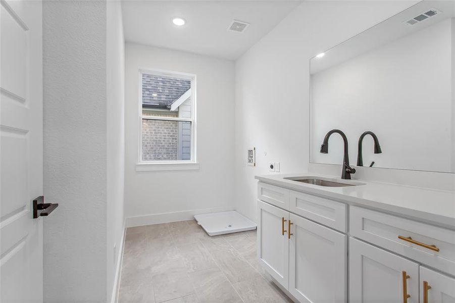 Bathroom with tile patterned floors and sink