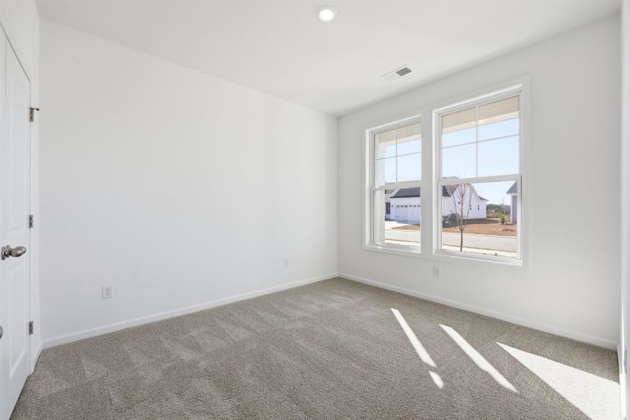 Empty room featuring carpet floors and baseboards Empty room featuring carpet floors and baseboards