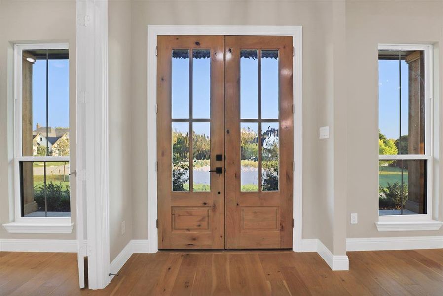 Doorway to outside with french doors, hardwood / wood-style flooring, and a wealth of natural light