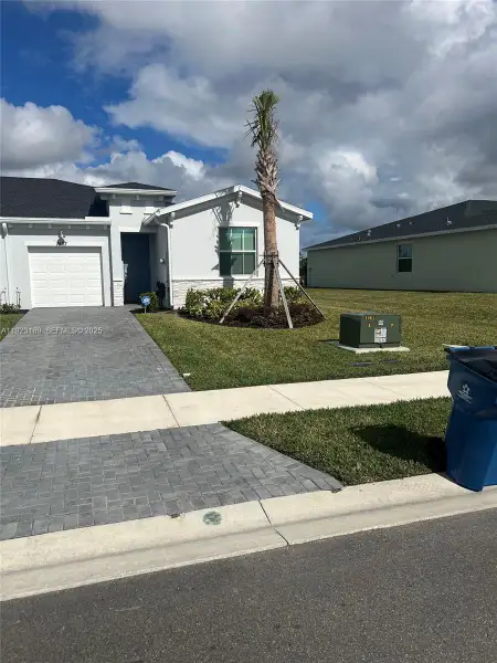 Front exterior of a new home in , Palm Bay, FL, highlighting curb appeal (Image 2). Front exterior of a new home in , Palm Bay, FL, highlighting curb appeal (Image 2).
