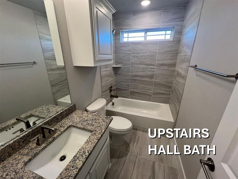Bathroom featuring a white vanity with a rectangular sink, granite countertop, and brushed nickel faucet Bathroom featuring a white vanity with a rectangular sink, granite countertop, and brushed nickel faucet