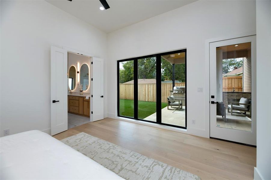 Bedroom with light wood finished floors, multiple windows, access to outside, recessed lighting, and ceiling fan Bedroom with light wood finished floors, multiple windows, access to outside, recessed lighting, and ceiling fan