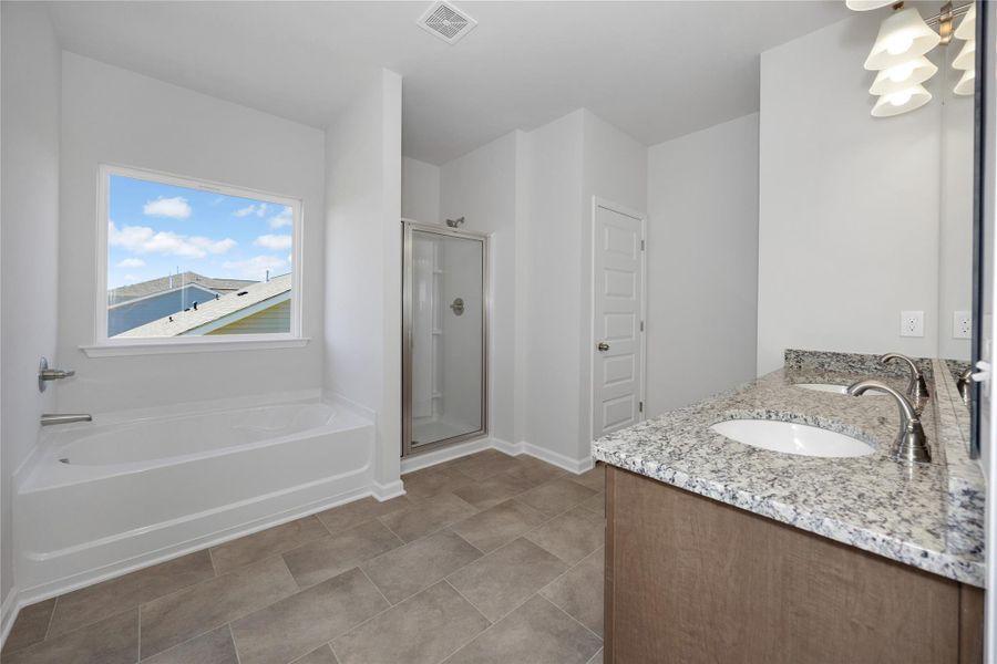The Harrington- Primary Bath with separate tub and shower. Sample image for illustration; upgrades, options, and colors may vary. The Harrington- Primary Bath with separate tub and shower. Sample image for illustration; upgrades, options, and colors may vary.