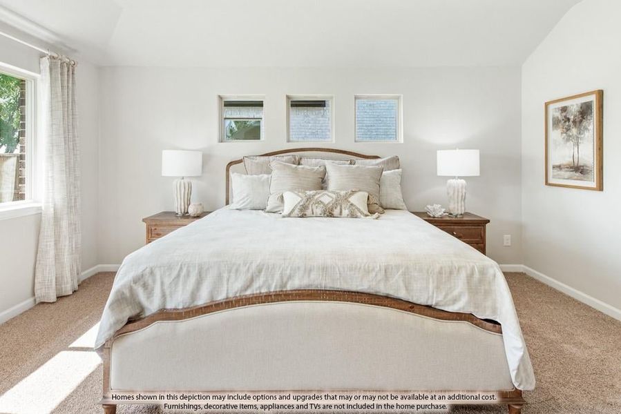 Bedroom with wood-framed bed, neutral bedding, two nightstands with lamps, and carpeted floors