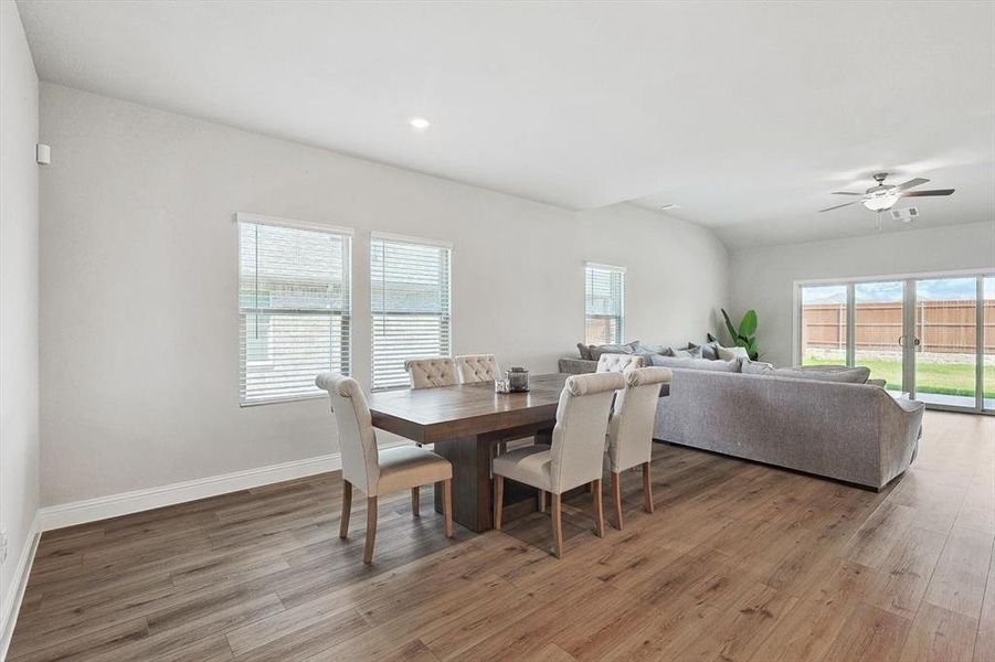 Dining room featuring ceiling fan and hardwood / wood-style flooring