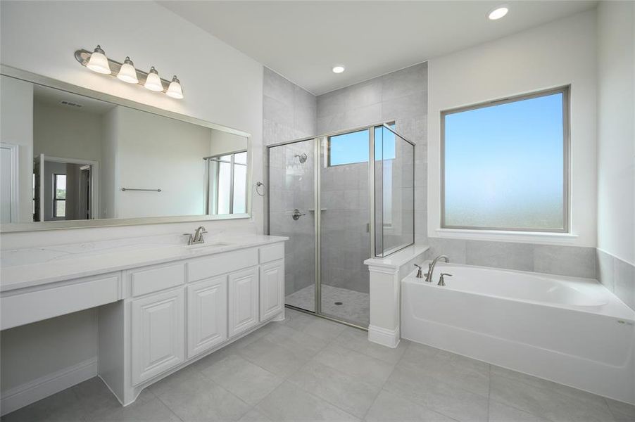 Bathroom with vanity and shower with separate bathtub