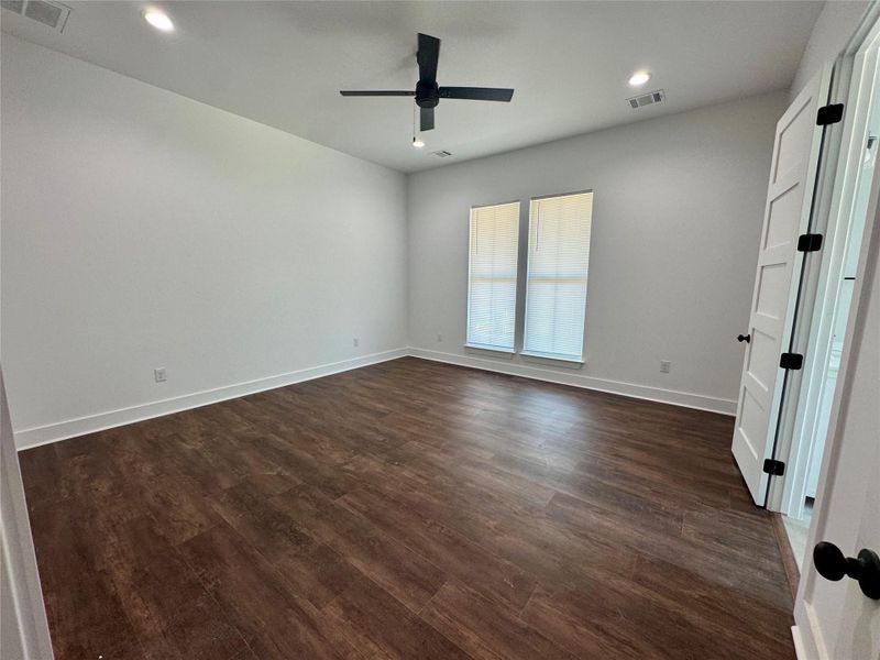 Empty room featuring dark wood-style flooring, recessed lighting, and a ceiling fan Empty room featuring dark wood-style flooring, recessed lighting, and a ceiling fan
