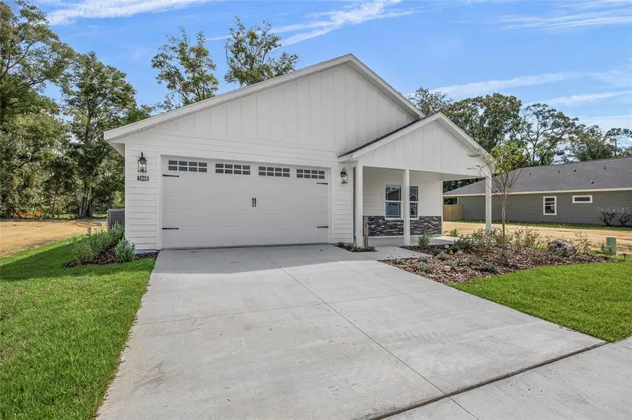 Front exterior of a new home in Grand Oaks, Gainesville, FL, highlighting curb appeal (Image 20).