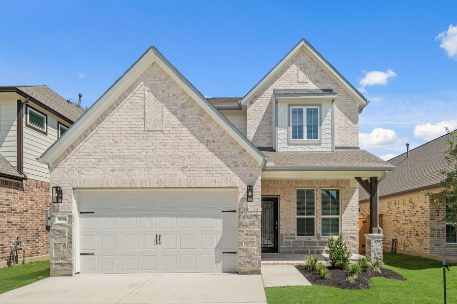 Front exterior of a new home in Sunterra, Katy, TX, highlighting curb appeal (Image 13).