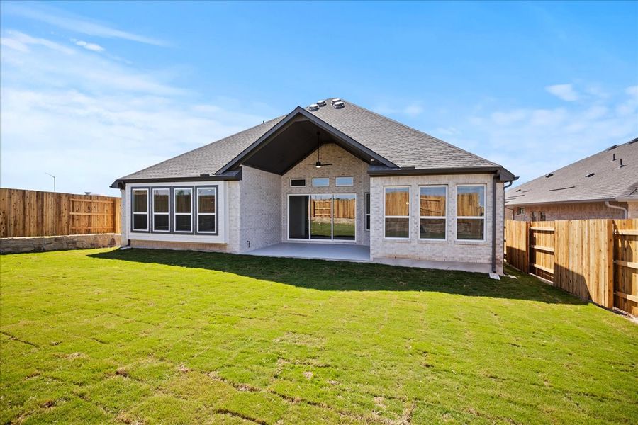 Representative exterior photo of a completed home built from the Farris by Chesmar Homes in Sunfield, Buda, TX (Image 12).