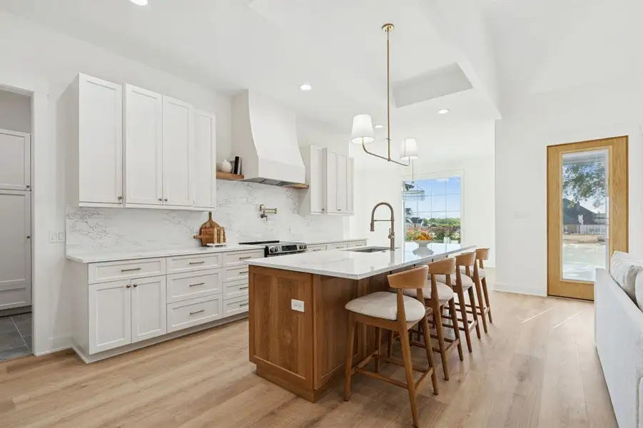 Two tone kitchen with custom-ordered soft close cabinets shipped from South Carolina. So much storage, and plenty of seating at the island.