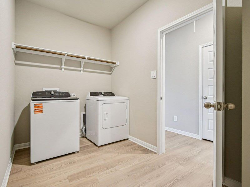 Washroom with washer and dryer and light wood finished floors Washroom with washer and dryer and light wood finished floors