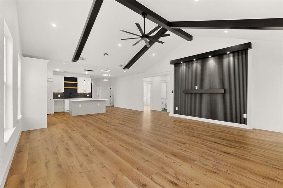 Unfurnished living room with a ceiling fan, light wood-style floors, and recessed lighting Unfurnished living room with a ceiling fan, light wood-style floors, and recessed lighting