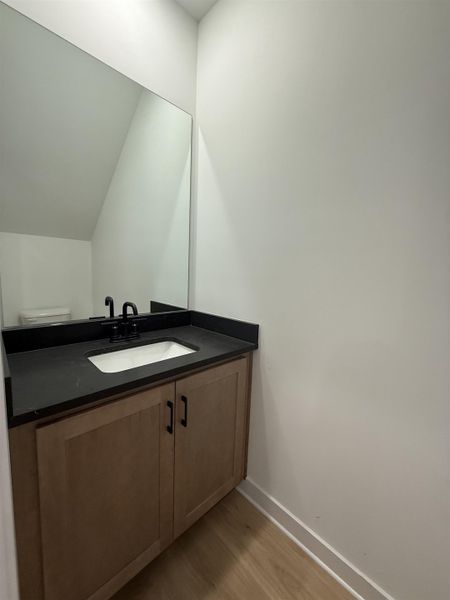 Bathroom featuring vanity and light wood finished floors