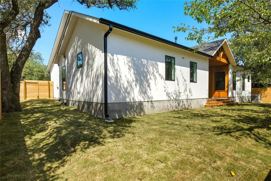 View of home's exterior back side with full gutters View of home's exterior back side with full gutters