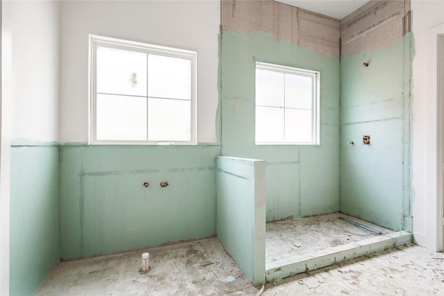Primary bath with freestanding tub and large shower.